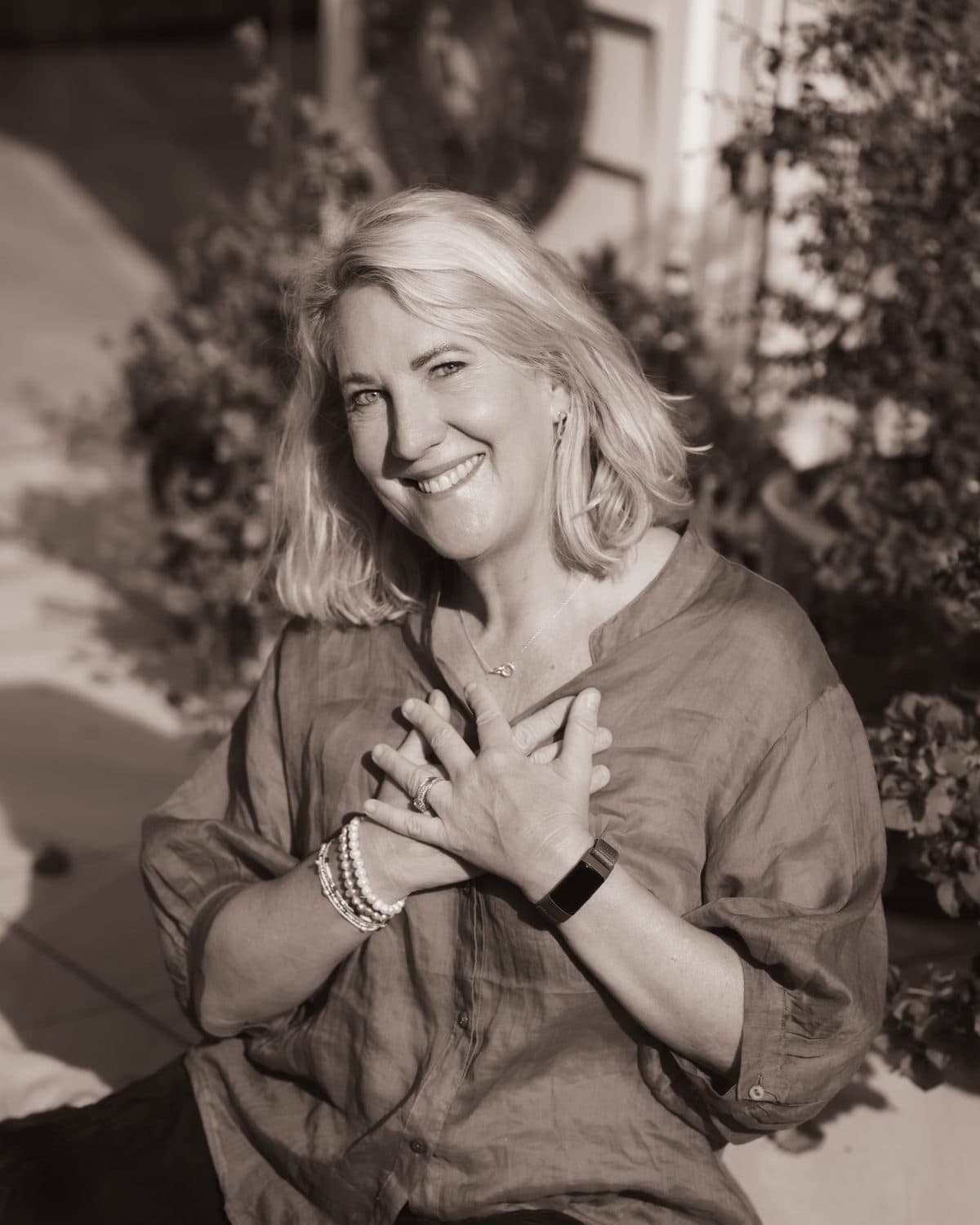 Debbie Thompson, hands on her heart, smiling