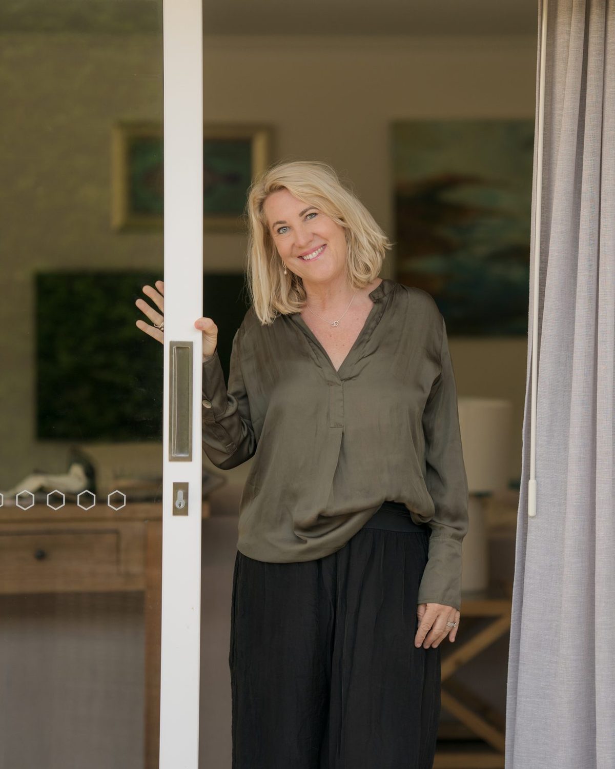 Debbie smiling in an open doorway